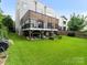 Green backyard features a deck and lush lawn, blending indoor-outdoor living with playset at 628 Cherry St, Charlotte, NC 28204