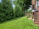 Lush backyard features mature trees, a well-manicured lawn, and privacy providing a serene outdoor oasis at 628 Cherry St, Charlotte, NC 28204