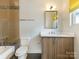 Bathroom features a bathtub, white toilet, wood vanity, and modern fixtures at 628 Cherry St, Charlotte, NC 28204