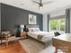 Modern bedroom with a dark accent wall, gray furnishings, a window, and hardwood floors at 628 Cherry St, Charlotte, NC 28204