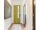 Modern entryway featuring an eye-catching chartreuse door and contemporary art at 628 Cherry St, Charlotte, NC 28204