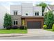 Modern home featuring mixed materials like brick and wood, plus a garage and verdant landscaping at 628 Cherry St, Charlotte, NC 28204