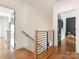 Hallway with wood floors, white walls, and a modern staircase and an open doorway at 628 Cherry St, Charlotte, NC 28204
