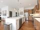 Spacious kitchen featuring stainless appliances, wood cabinets, a large island, and modern pendant lighting at 628 Cherry St, Charlotte, NC 28204
