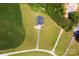 Overhead perspective revealing the property layout with lush farmland and mature trees nearby at 670 Cricket Ln, Mt Ulla, NC 28125