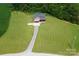 Aerial view of the home with a long driveway and beautiful green surroundings at 670 Cricket Ln, Mt Ulla, NC 28125