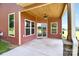 Charming covered back porch with wood ceiling, ceiling fan, and views of the backyard at 670 Cricket Ln, Mt Ulla, NC 28125