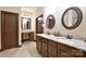 Spacious bathroom boasting dual sinks, granite countertops, and a vanity area for added comfort at 670 Cricket Ln, Mt Ulla, NC 28125