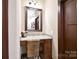 Bathroom vanity area with a granite countertop, drawers, and a large mirror at 670 Cricket Ln, Mt Ulla, NC 28125