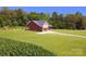 Attractive exterior view of the home showing the well-maintained lawn and surrounding greenery at 670 Cricket Ln, Mt Ulla, NC 28125