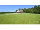 Charming two-story home with a welcoming front porch and a sprawling green lawn at 670 Cricket Ln, Mt Ulla, NC 28125