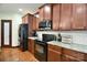 Close up of kitchen featuring stainless appliances, granite countertops, and wood cabinetry at 670 Cricket Ln, Mt Ulla, NC 28125