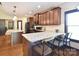 Open kitchen with dark cabinetry, granite counters, and island with bar seating at 670 Cricket Ln, Mt Ulla, NC 28125