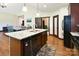 The kitchen island features a stainless dishwasher, granite countertops, and wood floors at 670 Cricket Ln, Mt Ulla, NC 28125