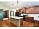 Kitchen features wood floors, stainless steel appliances, granite counters and a central island with seating at 670 Cricket Ln, Mt Ulla, NC 28125
