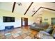 Spacious living room with vaulted ceilings, wood beams, and open layout to dining area at 670 Cricket Ln, Mt Ulla, NC 28125