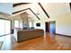 Bright living room with vaulted ceilings, exposed beams, stone fireplace, and hardwood floors at 670 Cricket Ln, Mt Ulla, NC 28125