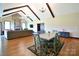 Open floor plan with hardwood floors and a dining area next to a fireplace at 670 Cricket Ln, Mt Ulla, NC 28125