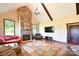 Living room with stone fireplace, hardwood floors, and large windows offering ample natural light at 670 Cricket Ln, Mt Ulla, NC 28125
