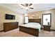 Elegant main bedroom featuring a ceiling fan, large window, and plush carpet at 670 Cricket Ln, Mt Ulla, NC 28125
