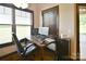 Home office with wood desk, comfortable chair, and natural light at 670 Cricket Ln, Mt Ulla, NC 28125