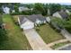 Aerial view of a single-story home with a two-car garage, situated on a well-maintained lot at 7616 Shiny Meadow Ln, Charlotte, NC 28215