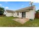 Spacious backyard with vinyl siding and patio area with sliding glass doors at 7616 Shiny Meadow Ln, Charlotte, NC 28215