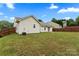 Spacious backyard featuring grassy lawn, partial fence, and view of neighboring homes at 7616 Shiny Meadow Ln, Charlotte, NC 28215