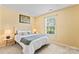 Bedroom with neutral walls, carpet, a window, a bed with side tables and lamps at 7616 Shiny Meadow Ln, Charlotte, NC 28215