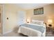 Relaxing bedroom featuring neutral walls, carpet, cozy bed with side table and lamp at 7616 Shiny Meadow Ln, Charlotte, NC 28215