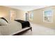 Inviting bedroom features neutral walls, two windows, and a comfortable-looking bed at 7616 Shiny Meadow Ln, Charlotte, NC 28215