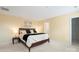 Comfortable bedroom features neutral walls, carpet, and a bed with side tables and lamps at 7616 Shiny Meadow Ln, Charlotte, NC 28215