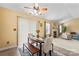 Cozy dining area with a wood table and seating, flowing into the living area with a fireplace at 7616 Shiny Meadow Ln, Charlotte, NC 28215