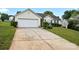 Single-story home with a two-car garage, concrete driveway, and well-maintained lawn at 7616 Shiny Meadow Ln, Charlotte, NC 28215