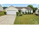Charming single-story home featuring a two-car garage, well-manicured lawn, and classic vinyl siding at 7616 Shiny Meadow Ln, Charlotte, NC 28215