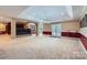 Basement area featuring a movie theater space with bar, french doors, seating, and carpeted flooring at 844 Clonmel Dr, Matthews, NC 28104
