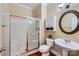 Bathroom featuring a shower with glass doors, tiled flooring, and pedestal sink at 844 Clonmel Dr, Matthews, NC 28104