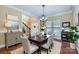 Elegant dining room featuring hardwood floors, crown molding, and natural light from large windows at 844 Clonmel Dr, Matthews, NC 28104