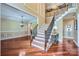 Grand foyer showcasing hardwood floors, staircase with iron railings, and elegant chandelier at 844 Clonmel Dr, Matthews, NC 28104