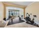 Home gym including exercise bike, free weights, multiple windows, and carpeted and rubber mat flooring at 844 Clonmel Dr, Matthews, NC 28104