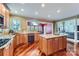 Well-designed kitchen with granite countertops, wood cabinets, stainless steel appliances, and hardwood floors at 844 Clonmel Dr, Matthews, NC 28104