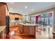Well-lit kitchen with granite counters, stainless appliances, wood floors, island and open to dining area at 844 Clonmel Dr, Matthews, NC 28104