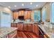 Bright kitchen with granite countertops, wooden cabinets, modern appliances, and hardwood floors at 844 Clonmel Dr, Matthews, NC 28104