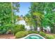 This backyard offers a tranquil view of the lake and a private pool nestled amidst lush greenery at 844 Clonmel Dr, Matthews, NC 28104