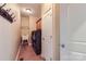 Laundry room featuring tile floor, washer and dryer, utility sink, and storage shelving at 844 Clonmel Dr, Matthews, NC 28104