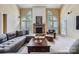 Inviting living room features a stone fireplace, large windows, and comfortable seating arrangement at 844 Clonmel Dr, Matthews, NC 28104