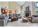 Spacious living room with a stone fireplace, high ceilings, and a comfortable sectional sofa at 844 Clonmel Dr, Matthews, NC 28104