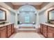 Relaxing bathroom with dual vanities, elegant pillars, and a luxurious soaking tub at 844 Clonmel Dr, Matthews, NC 28104