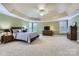 Inviting main bedroom with neutral walls, tray ceiling, carpet, and coordinating furnishings at 844 Clonmel Dr, Matthews, NC 28104