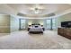 Spacious main bedroom with a tray ceiling, large windows, and comfortable furnishings at 844 Clonmel Dr, Matthews, NC 28104